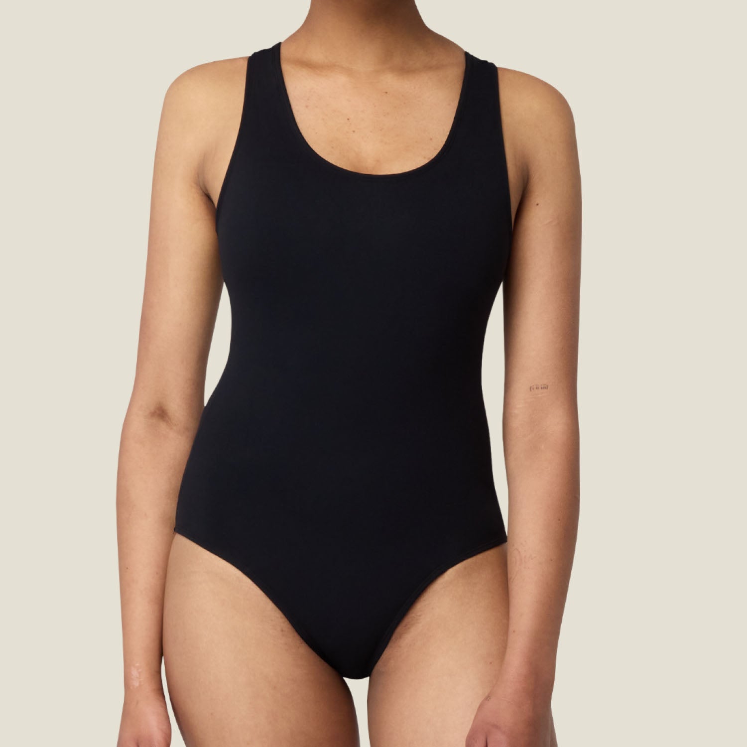 Close-up of WUKA black racerback period swimsuit – front view highlighting smooth, minimalist design for leak-proof protection during medium flow
