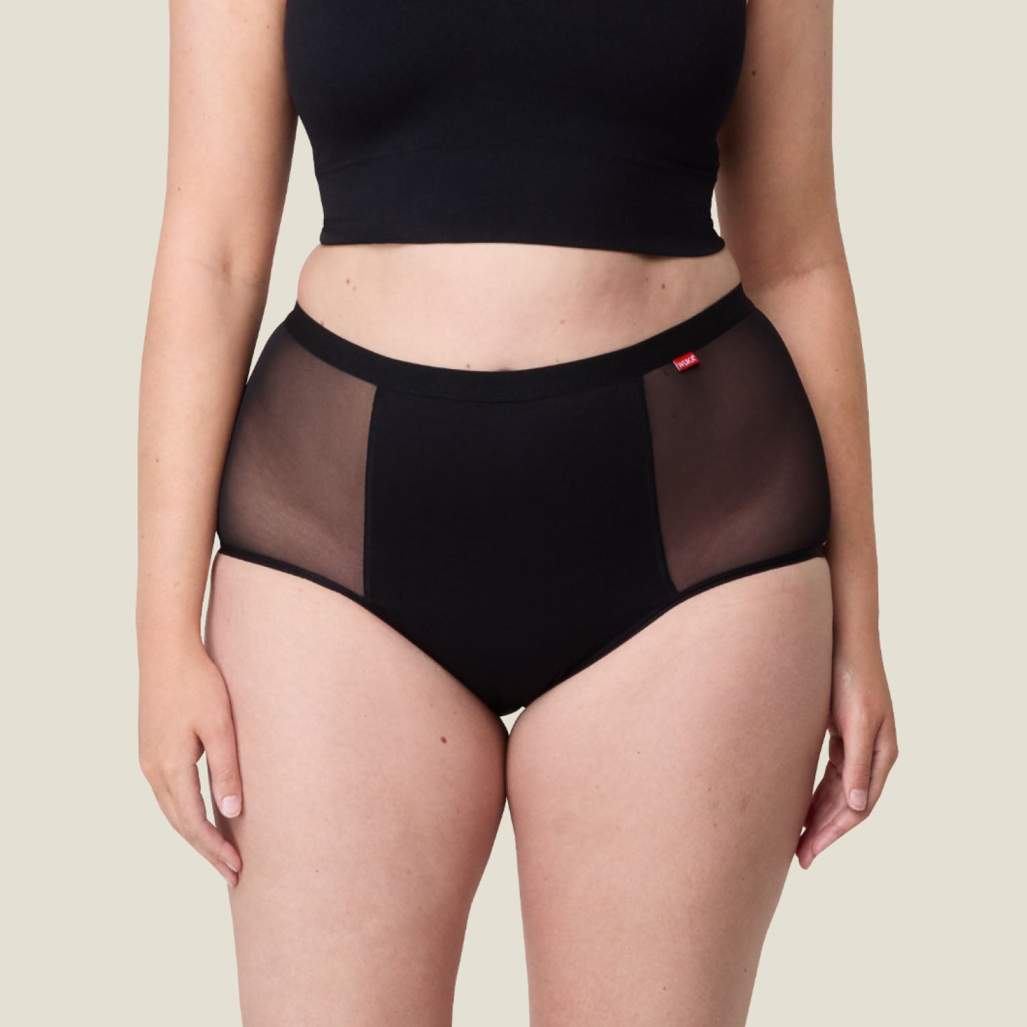Close-up of WUKA Ultimate™ High Waist Period Pants – breathable black underwear with mesh side panels for heavy flow menstrual protection.