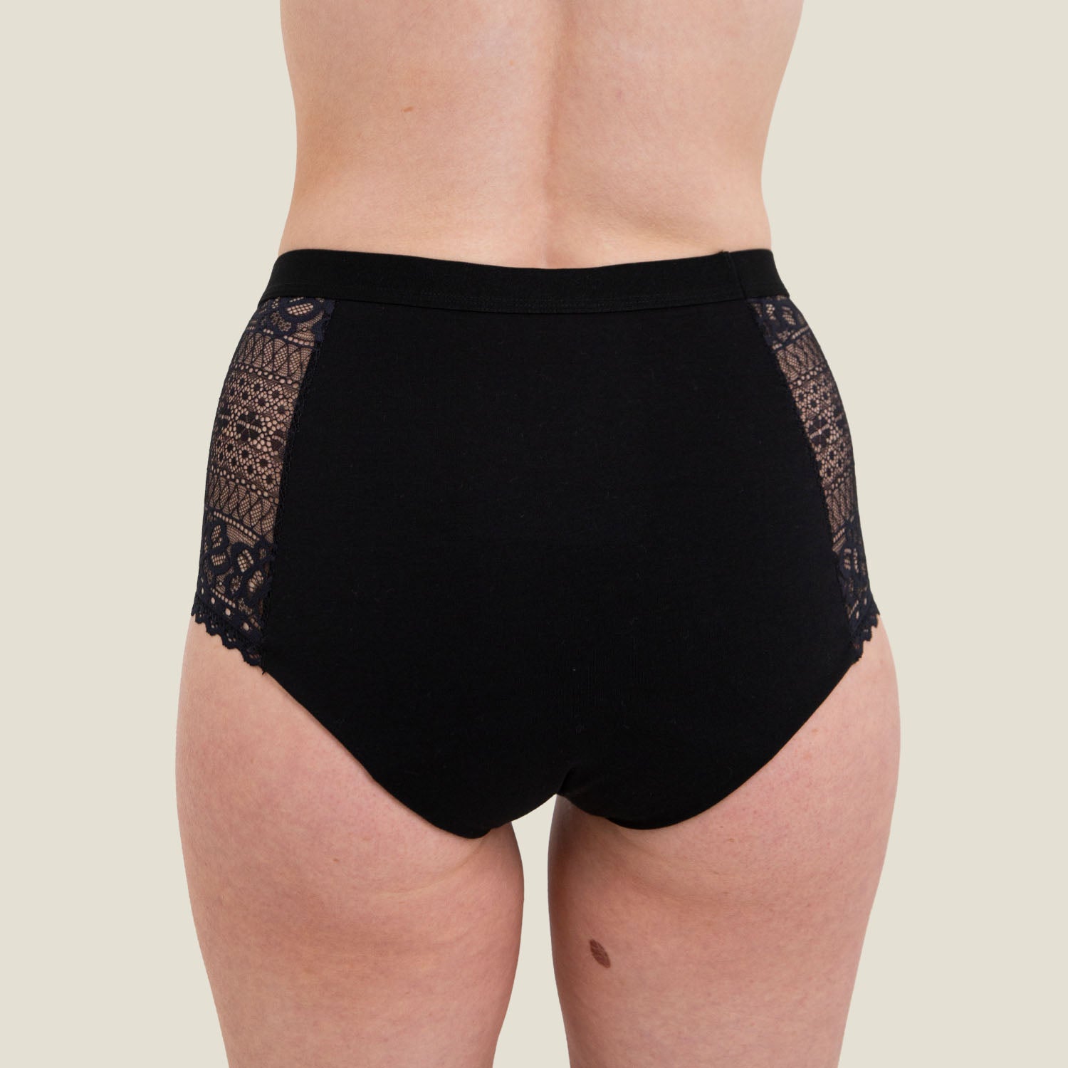 Rear view of WUKA Ultimate™ Lace High Waist Period Pants in black, showing full coverage design and lace side panels for style and comfort.