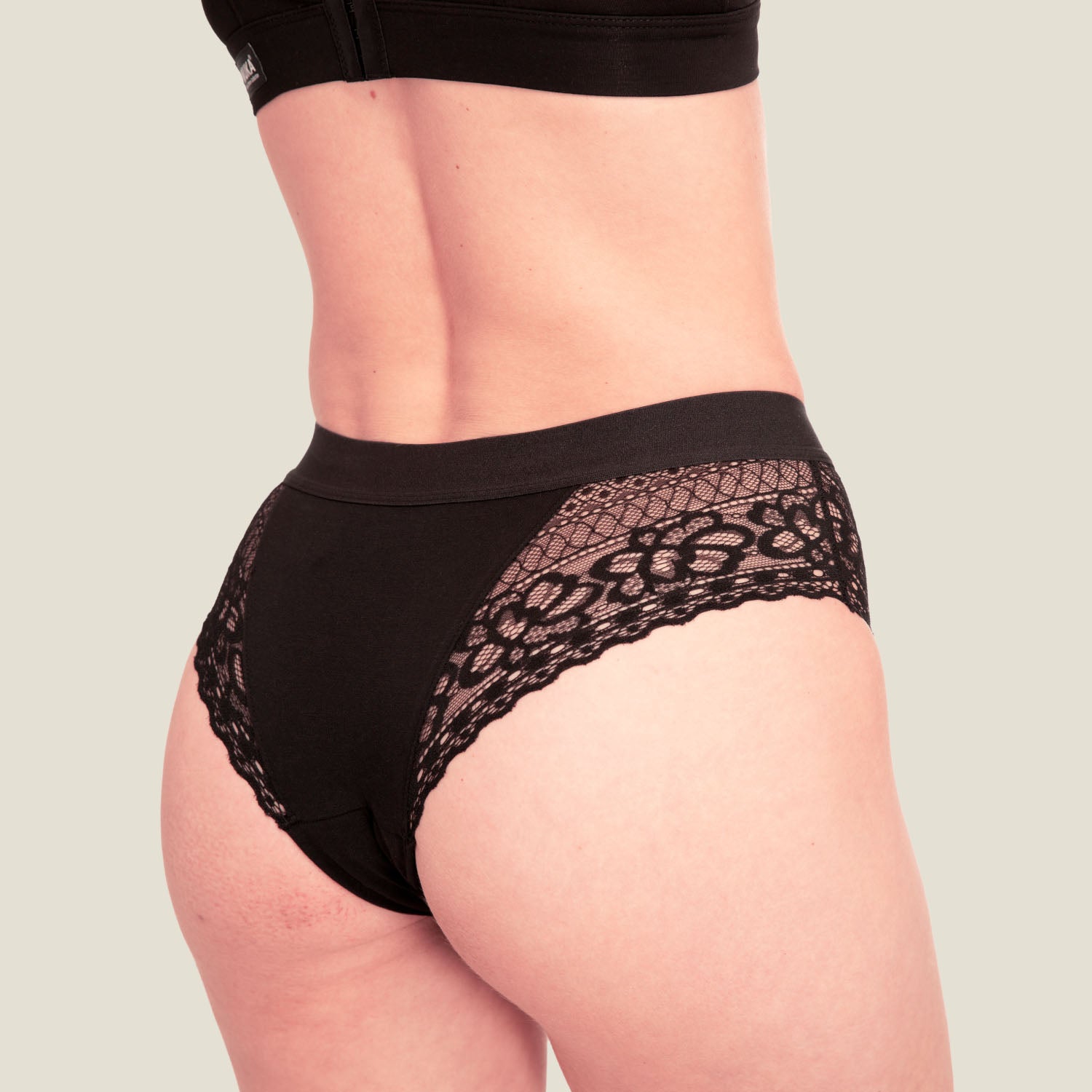 Side profile of WUKA Ultimate™ Lace Hipster Brief – black period underwear with breathable cotton core and soft stretch lace sides, ideal for medium menstrual flow.