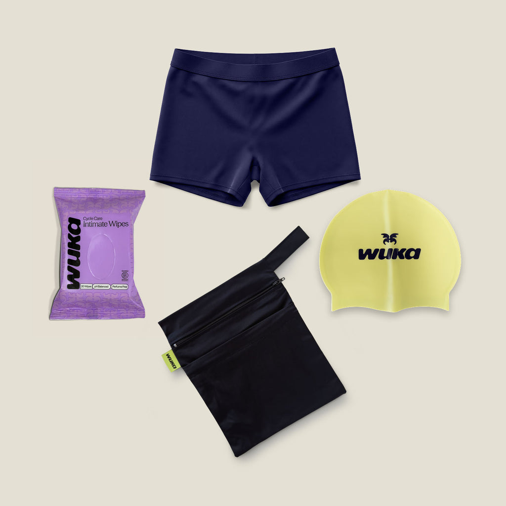 Women’s period-proof navy swim shorts starter kit with waterproof bag, swim cap and intimate wipes by WUKA