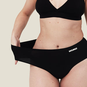 Close-up showing the extreme stretch of WUKA Stretch™ period underwear, fitting up to 4 sizes.