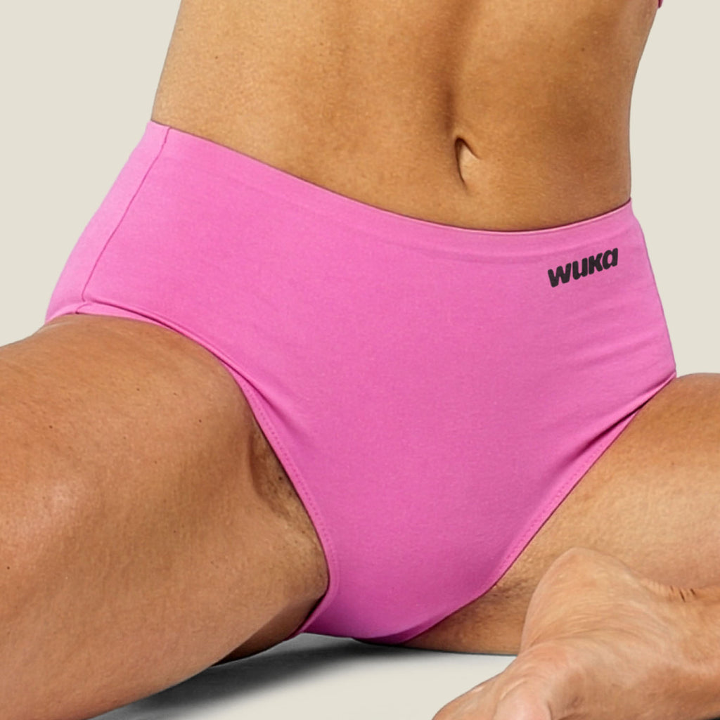 Close-up lifestyle image of WUKA Stretch™ Midi Brief in Pink for heavy flow, featuring ultra-soft, stretchy fabric designed to fit multiple sizes. Leak-proof, sustainable period underwear offering 12-hour protection and a comfortable, secure fit.