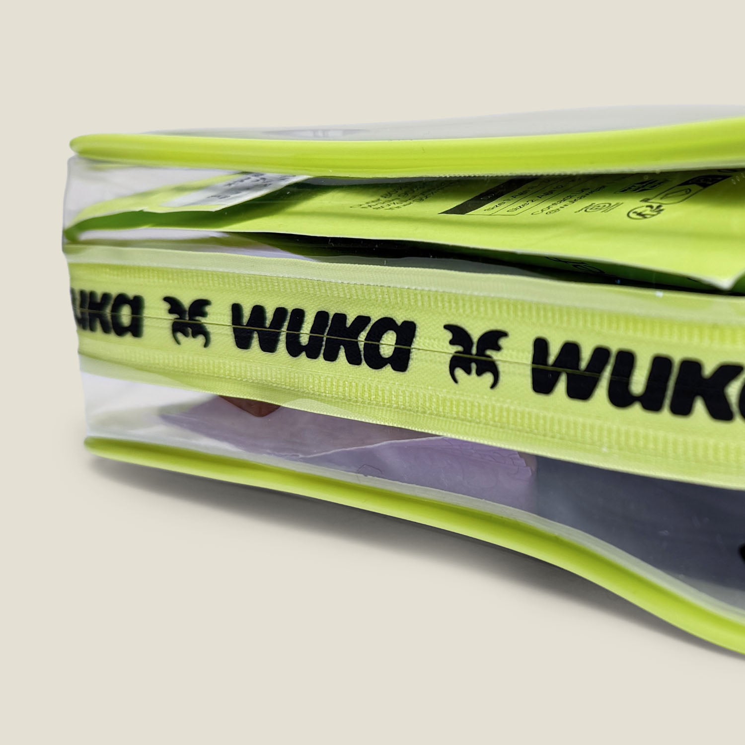 Close-up of WUKA branded zipper on clear period starter kit bag with first period essentials visible inside